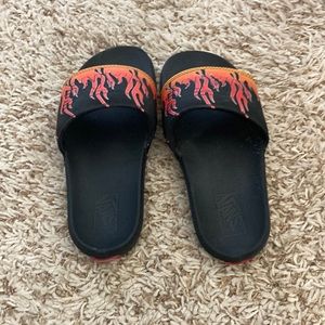 vans red, black, and orange fire slides
